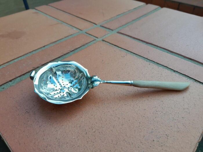 A Silver Tea Strainer with Bone Handle 38g weight