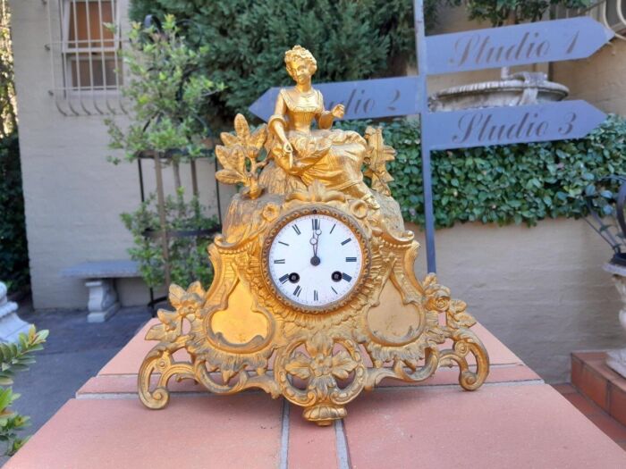 A 19th Century French Gilt Spelter Clock with Pendulum and Key