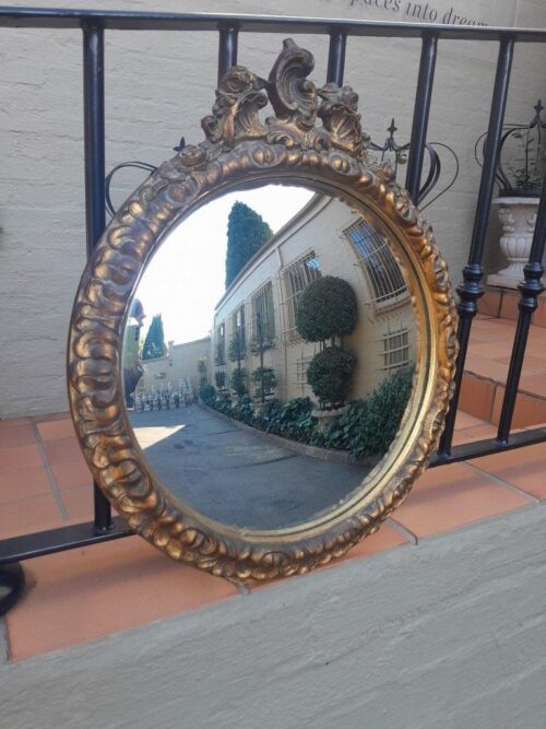 A 20th Century Ornately Carved Gilt Framed Convex Mirror