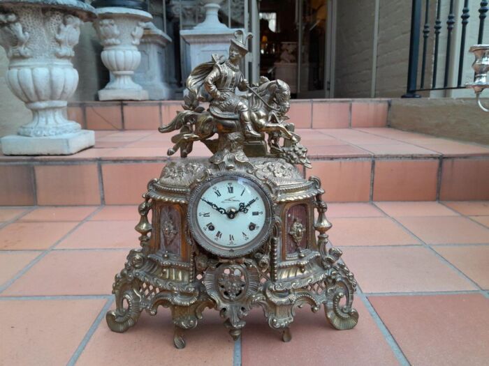 A 20th Century Decorative French Empire Style Brass Clock