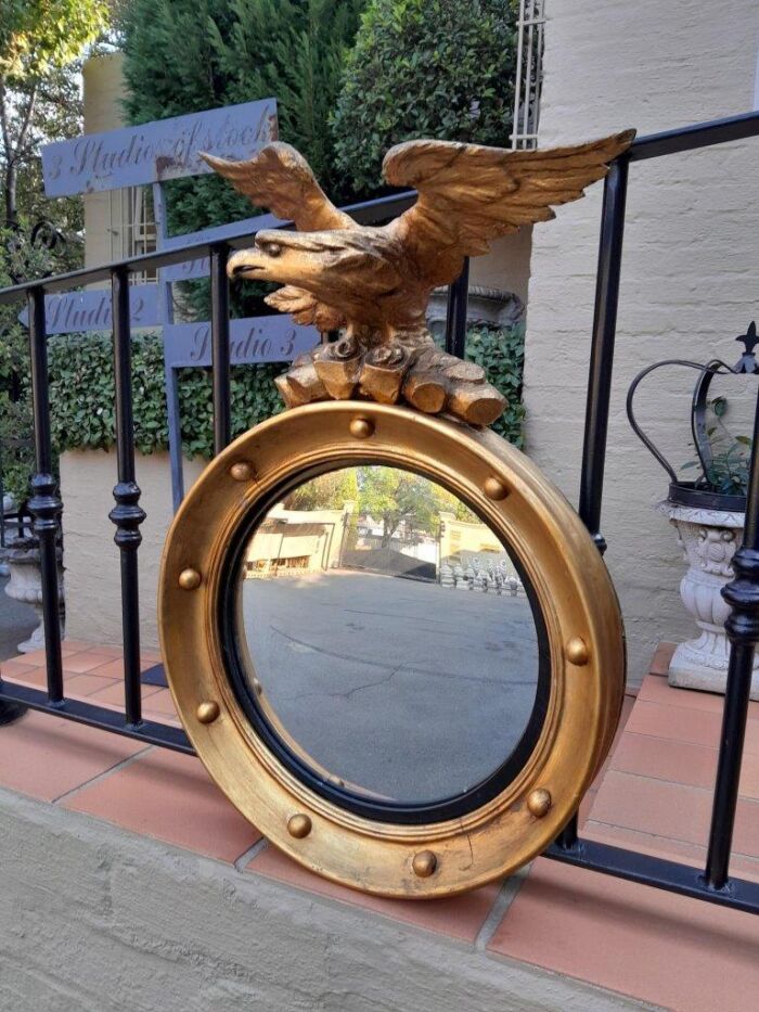 A 20TH Century Regency Style Eagle Gilt Painted Convex Mirror