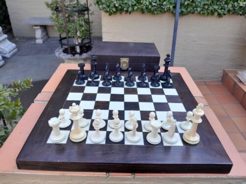 A 20th Century Hand Carved Ebony And Ivory Chess Set With Board And Leather Case