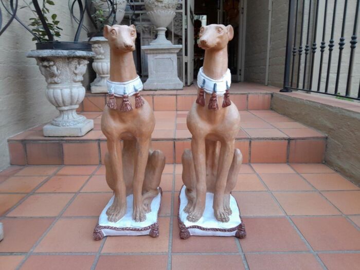 A 20th Century Pair Of Ceramic Whippets On Cushion Bases