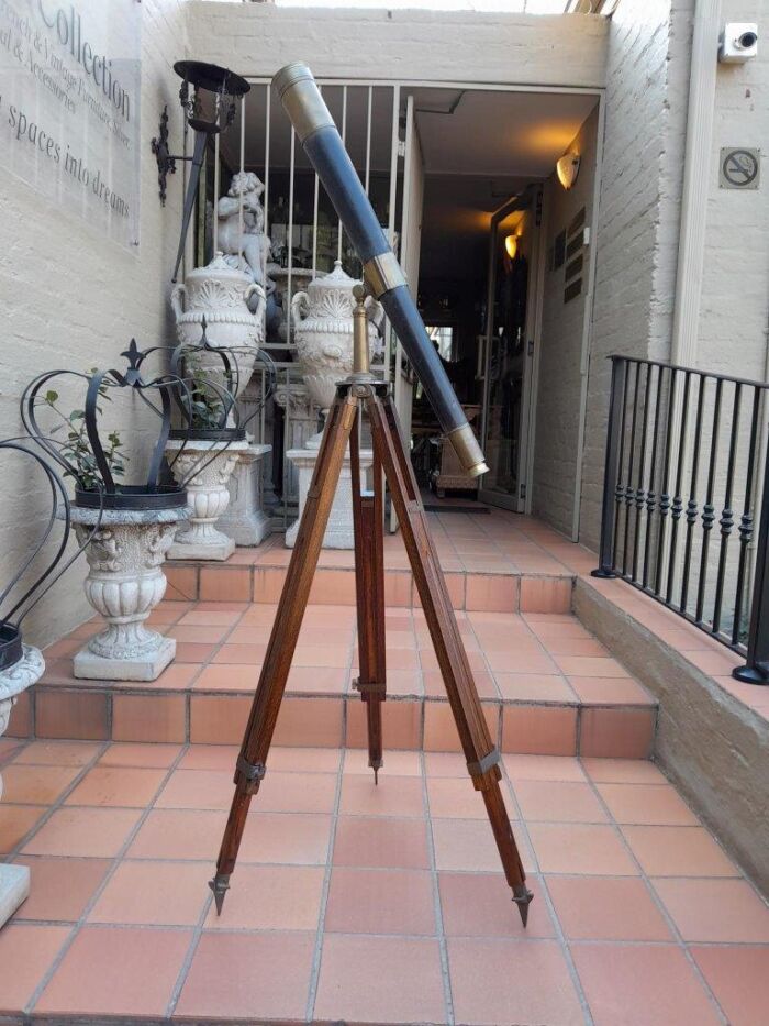 An Antique Brass And Leather Telescope On Brass And Oak Tripod Stand