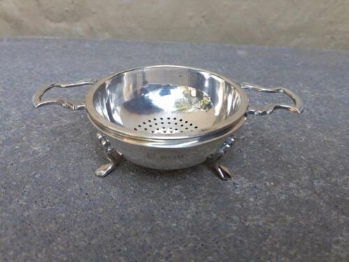 An English Elizabeth II Circa 1956 Georgian-style  Silver Tea Strainer  on Feet  Dimensions:  3.5cmH x 12cmD (Weight 61g)