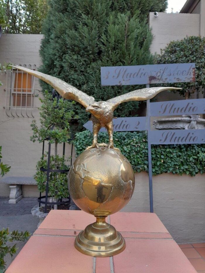 A 20th Century Brass Eagle On World Globe