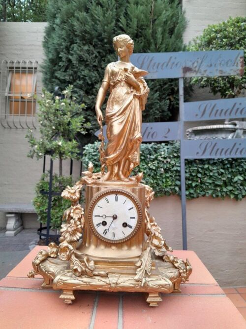 An Antique French Louis XVI Figural Clock with Pendulum and Key