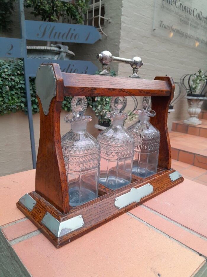 An English Oak Tantalus with 3 Glass Decanters & Metal Hardware - Image 2