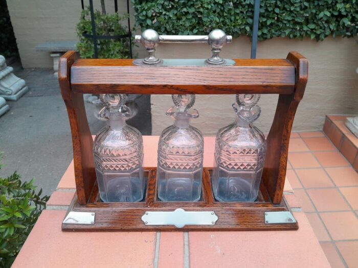 An English Oak Tantalus with 3 Glass Decanters & Metal Hardware - Image 3