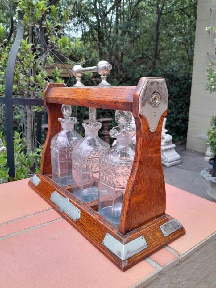 An English Oak Tantalus with 3 Glass Decanters & Metal Hardware - Image 4