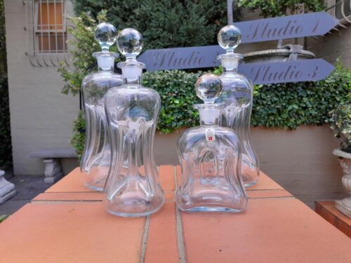 A Set Of Four Glug Glug Decanters