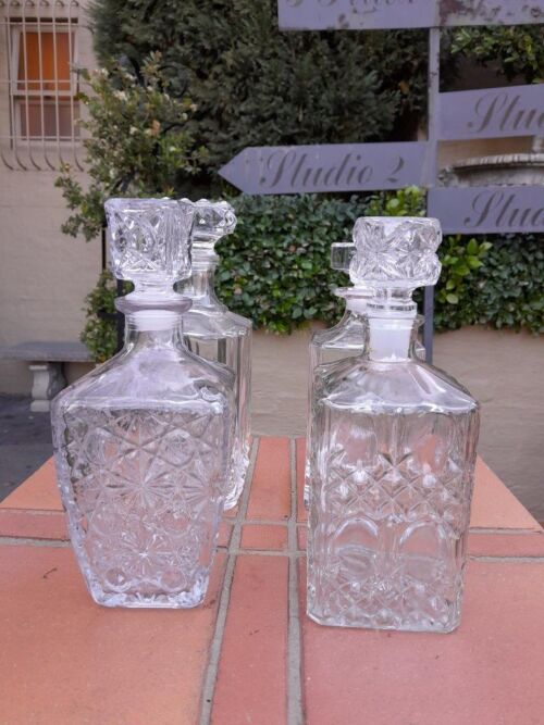 A Set Of Two Crystal Decanters And Two Cut Glass Decanters