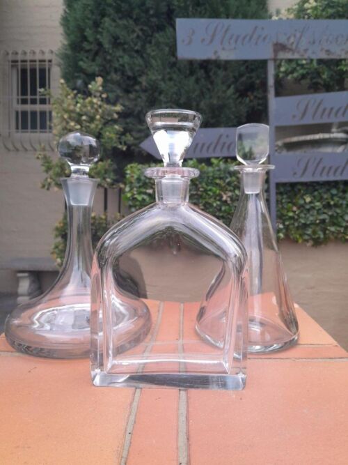 A Set of Three Glass Decanters