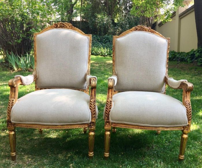 A Pair of French Louis XVI Styled Ornately carved and gilded Fautelli  Chairs in Linen Upholstery