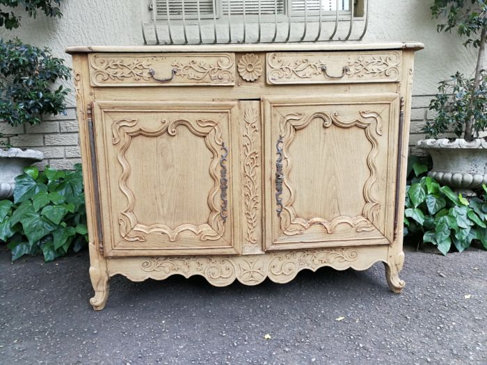 A Provincial Style French Oak Server in a Contemporary Bleached / Natural Wood Finish with Cream Marble Top