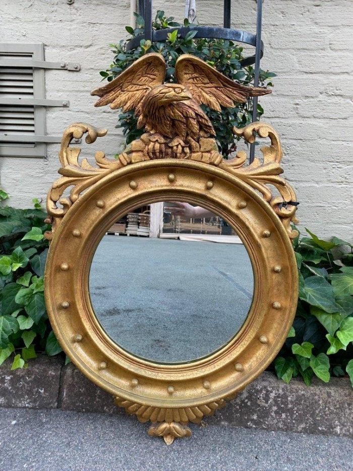 A circular framed 19thC style mirror with eagle crest