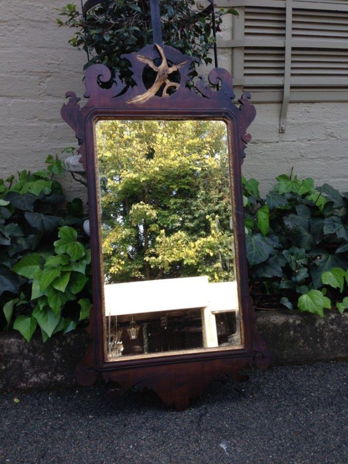 A Georgian mahogany mirror with an eagle