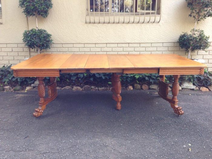 American Colonial oak extending dining table with lion paw feet