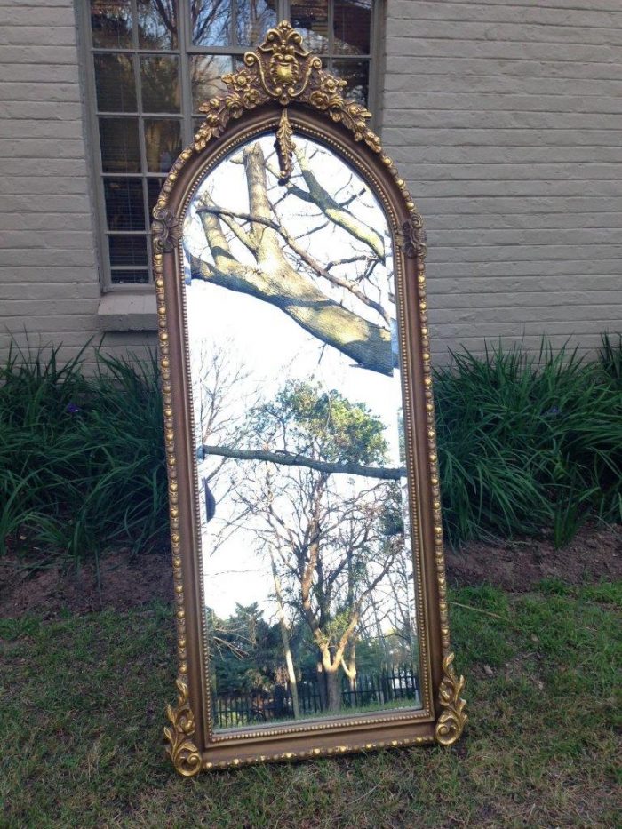 An Ornate Carved Arched Bevelled Mirror