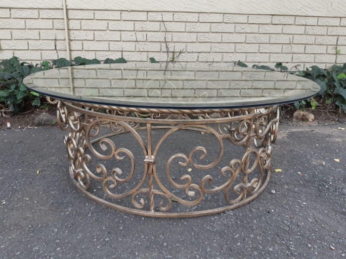 Round wrought iron coffee table with glass top with thick bevelled glass top