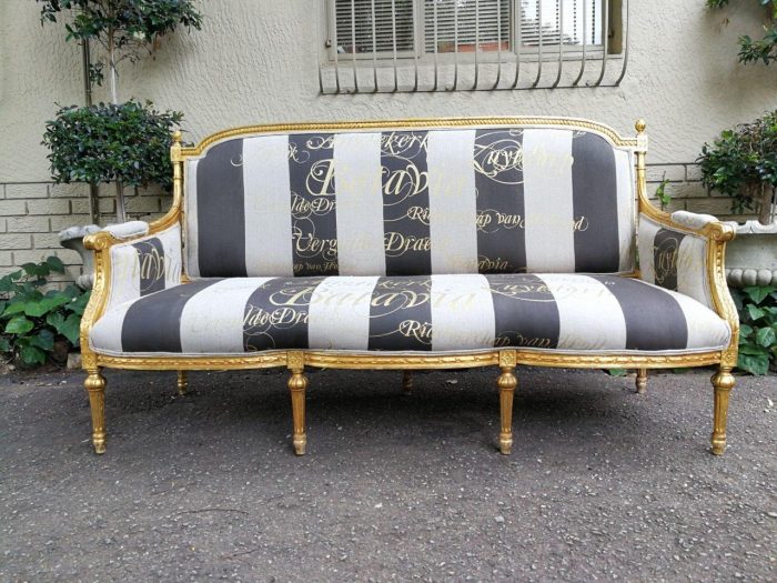 A French Antique Hand -Carved And  Gilded  Settee Upholstered In An Imported English Linen