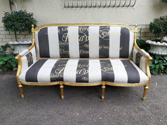 A French Antique Hand-Carved And Gilded Settee, Upholstered In A Hand Painted Imported Linen Fabric With Gold Script - Image 2