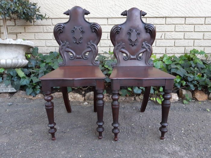 A Pair Of Victorian Mahogany & Stained Oakwood Cartouche Back Hall Chairs