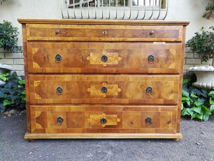 A Walnut And Inlaid Chest-Of-Drawers