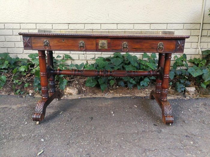 A William IV Rosewood Library Table With Brass Gallery On Brass Castors