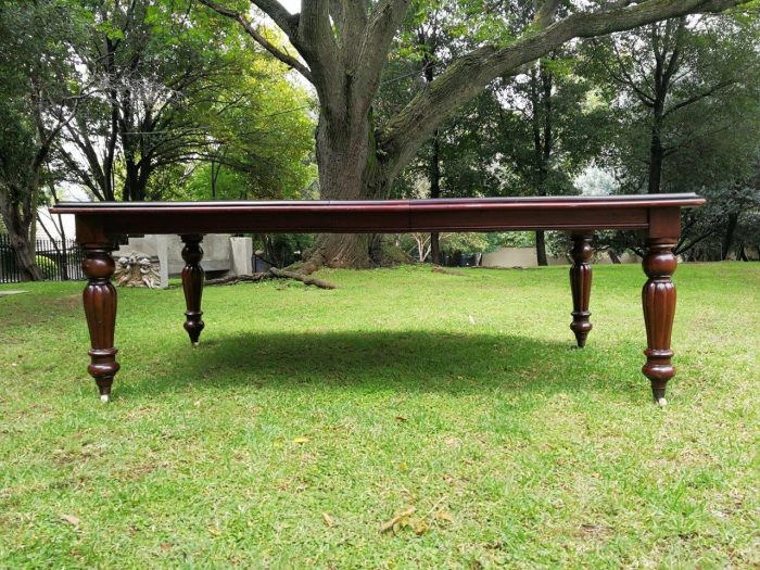 A Victorian Style Mahogany extending ten-seater dining room table on brass castors and with winding crank (10 Seater) - Image 2