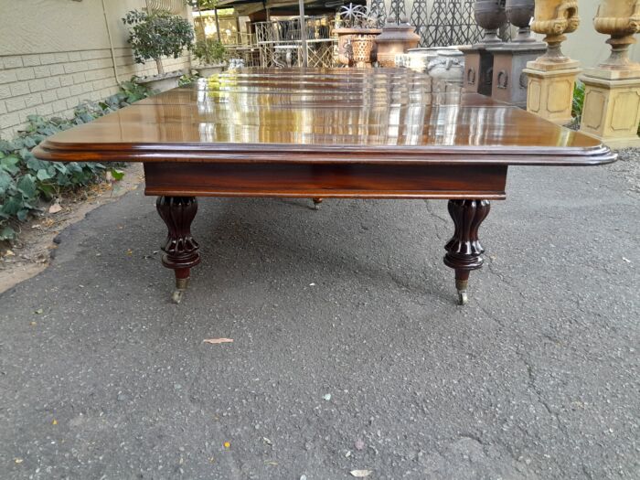 A Massive and Rare Victorian Mahogany Dining / Boardroom Extension table with Four Extensions and Fifth Supporting Leg in the Middle on Original Brass Castors - Image 6