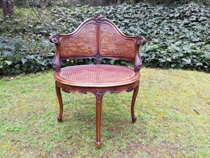 A French Walnut Carved And Rattan Chair