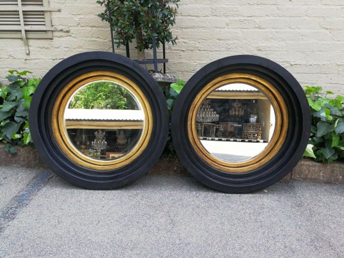 A Pair Of Circular Bevelled Wooden Mirrors with a Hand-gilded Gold Leaf Detail