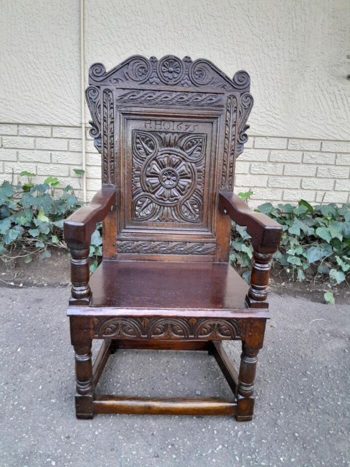 An 18th / 19th Century Carved Oak Wainscot Armchair the date and initials H. HO