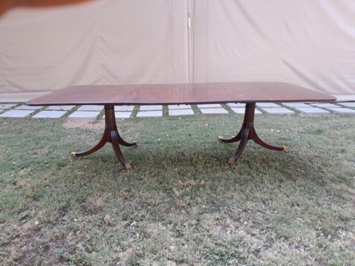 A 20th Century Mahogany Dining Table with Two Extensions and Brass Feet & Casters