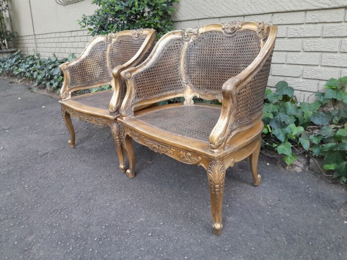 A 20th Century Pair or French Bergere Style Carved and Hand Gilded in Gold Leaf Wooden Chairs - Image 4