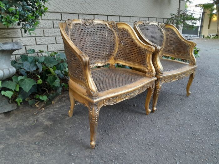 A 20th Century Pair or French Bergere Style Carved and Hand Gilded in Gold Leaf Wooden Chairs - Image 5