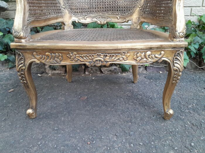 A 20th Century Pair or French Bergere Style Carved and Hand Gilded in Gold Leaf Wooden Chairs - Image 9