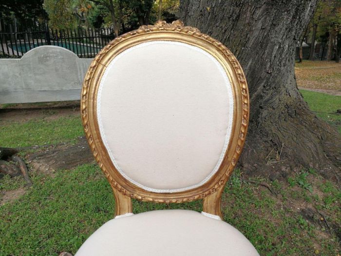 A 20th Century French Style Imported Set Of Twelve Gilded Dining Chairs Comprising: Two Carvers  /  Armchairs With Rattan Backs And Ten Dining Chairs