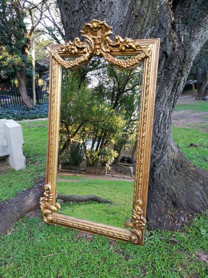 A French Style Ornately Carved and Gilded Bevelled Mirror