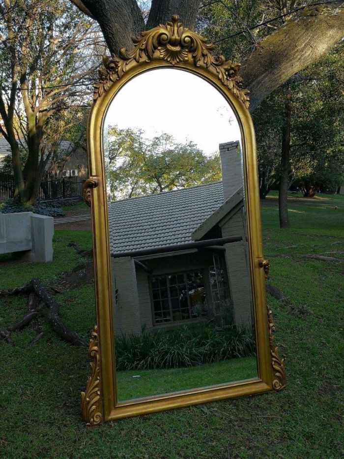 A French Style Ornately Carved Arched and Gilded Bevelled Mirror