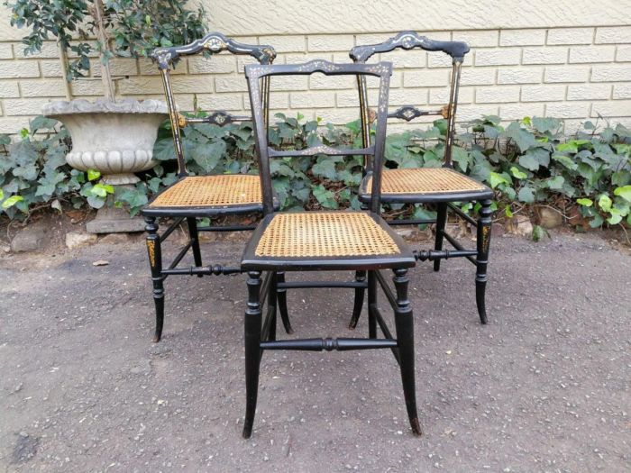 A Pair Of Victorian Circa 1880s Ebonised Chinoiserie And Gilt-Painted With Mother-Of-Pearl Inlaid Chairs And A Single Similar Chair