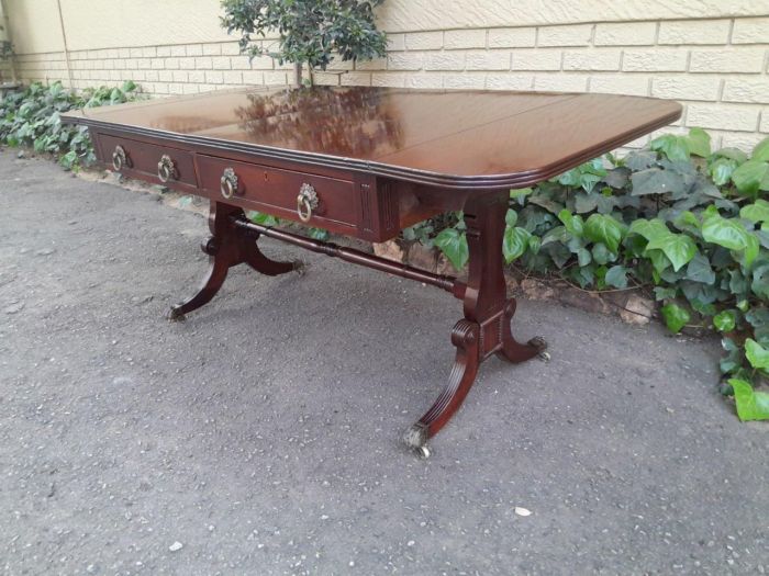 A Victorian Circa 1870, Mahogany Drop-side Library Table, With Drawers and Brass Escurcheons (the opposite reverse fitted with conforming dummy drawers) With Brass Paw Feet - Image 4