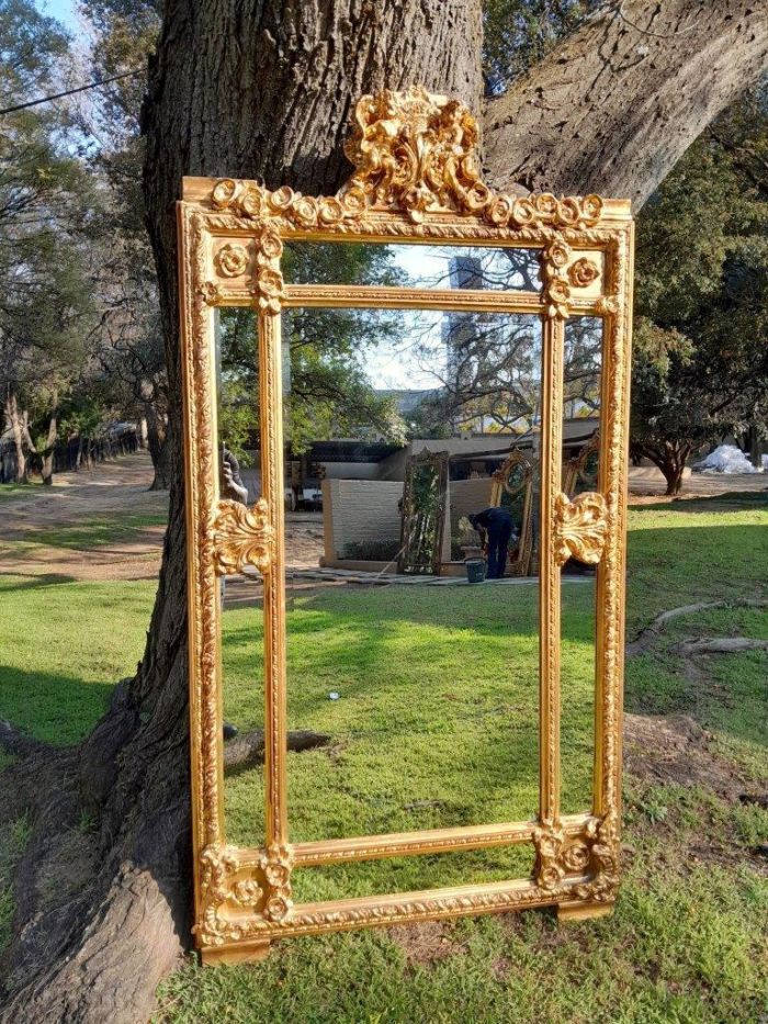 A French Style Ornately Carved and Gilded Bevelled Mirror