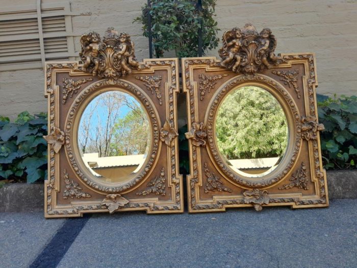 An Exceptional Pair of 20th Century French Style Ornately Carved and Gilded Bevelled Mirrors with Cherubs