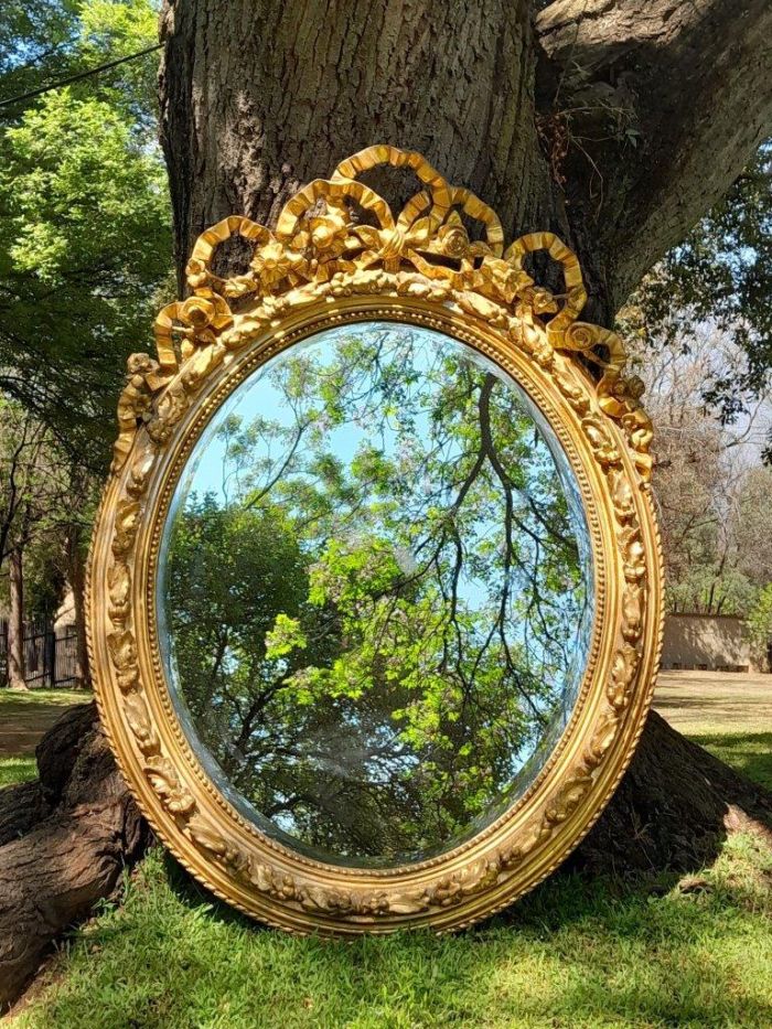 A French Rococo Style Ornately Carved and Gilded Oval Bevelled Mirror - Image 2