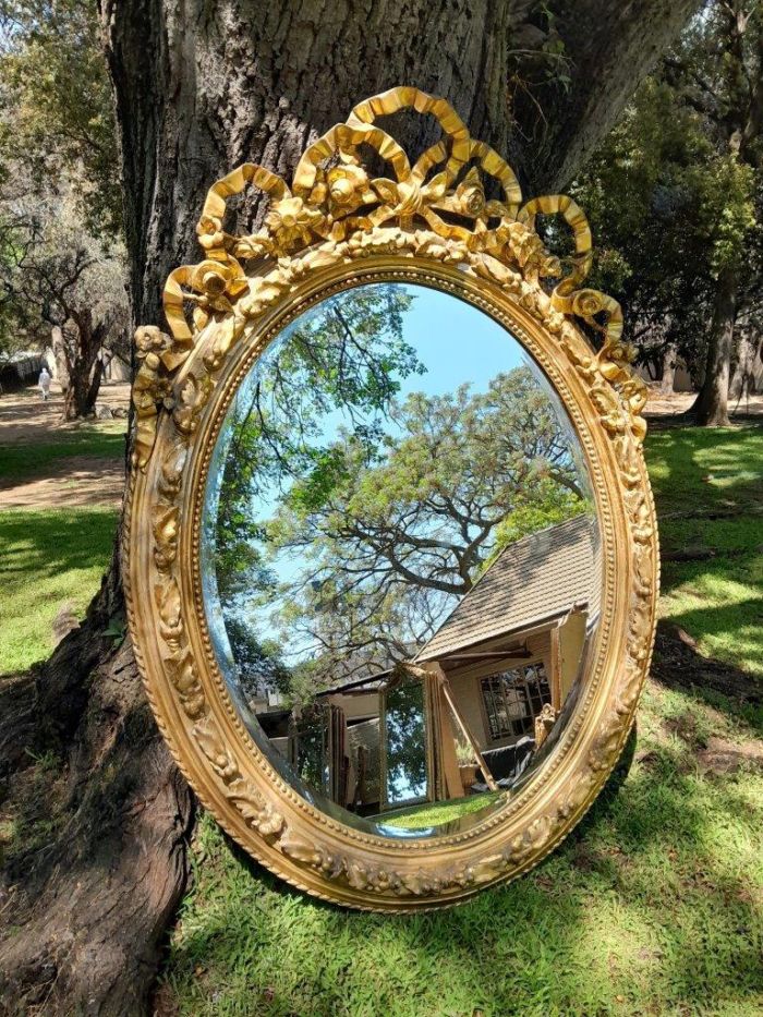 A French Rococo Style Ornately Carved and Gilded Oval Bevelled Mirror - Image 3