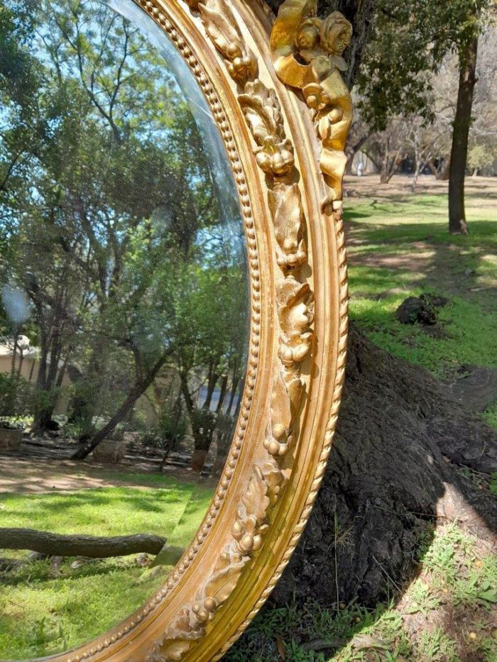 A French Rococo Style Ornately Carved and Gilded Oval Bevelled Mirror - Image 5