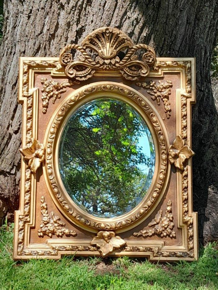 A 20th Century French Style Ornately Carved and Gilded Bevelled Mirror