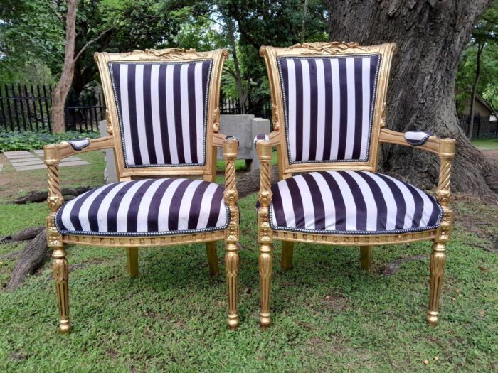 A Pair Of 20th Century French Louis XVI Styled Ornately Carved And Gilded Fautelli Chairs (various upholstery options - please specify your preference)